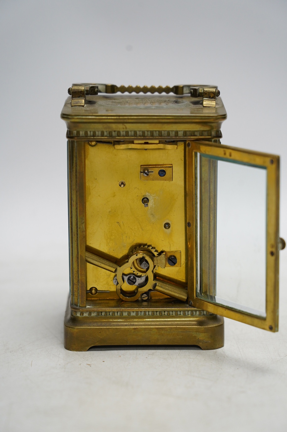 A brass cased carriage timepiece with enamel dial, with key, 15cm high. Condition - good, not tested